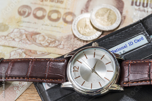 Watch and wallet on banknote