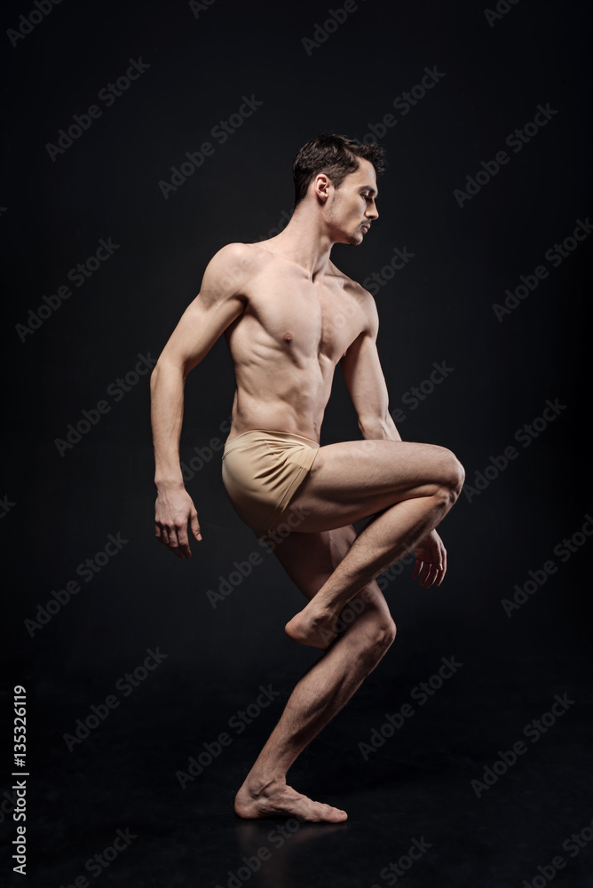 Naklejka premium Involved gymnast performing in the studio