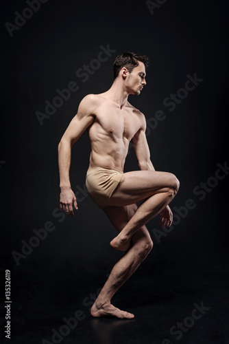 Involved gymnast performing in the studio