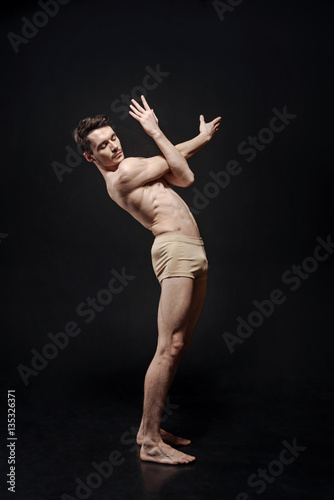 Flexible young ballet dancer performing in the studio