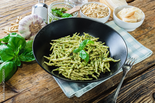 Trofie pasta with vegetarian sauce, pesto with pine nuts and bas photo