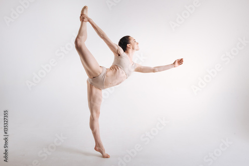 Slim ballet dancer standing on the tiptoe in the studio