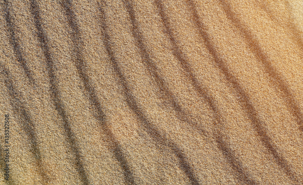Beach sand patterns in warm evening sunlight Beach sand patterns in warm evening sunlight