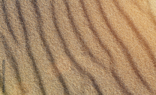 Beach sand patterns in warm evening sunlight