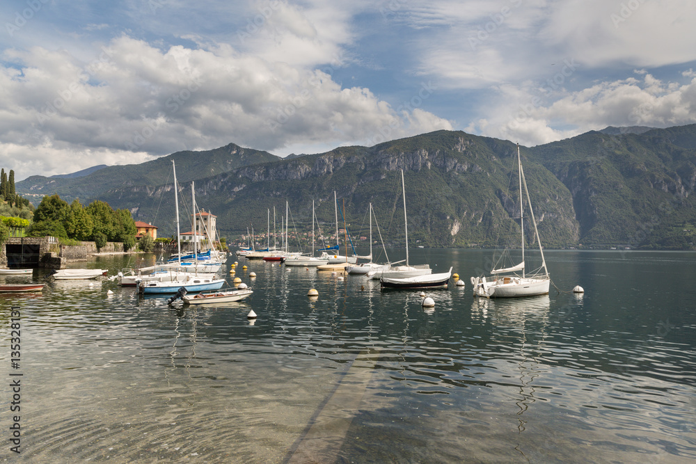 Boats in Bellagio on Lake Como with an alpine view