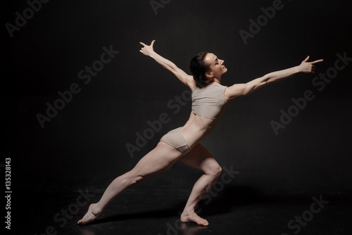 Airy young ballet dancer posing in the studio