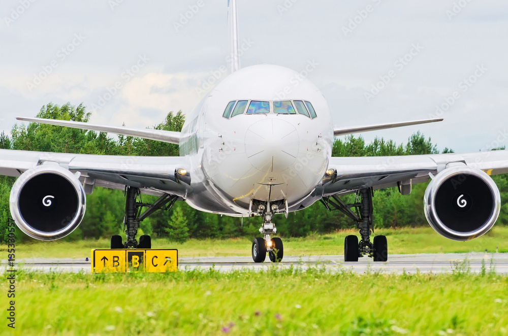 Fototapeta premium Airplane blue sky clouds flight airport grass green taxi