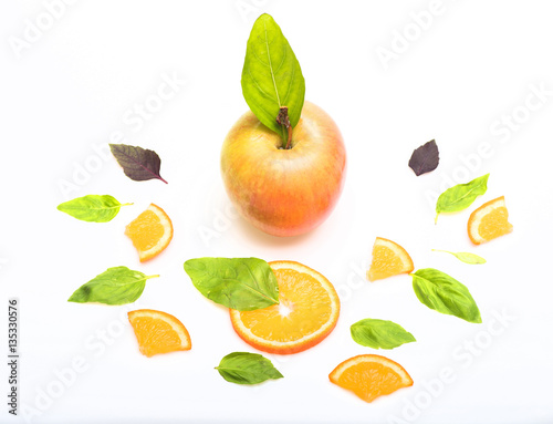 green mint leaves, apple and orange dessert isolated on white
