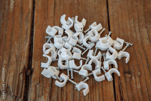 Wallpaper Mural Cable clip round white with a nail on  background Torontodigital.ca