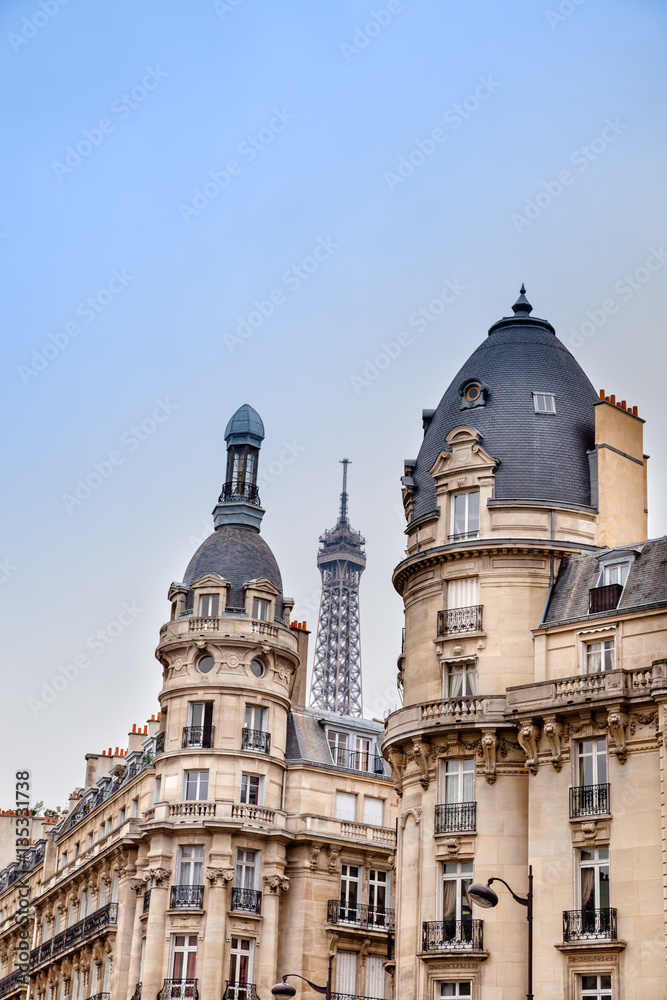 Parisian apartment building, and the Eiffel Tower on the background