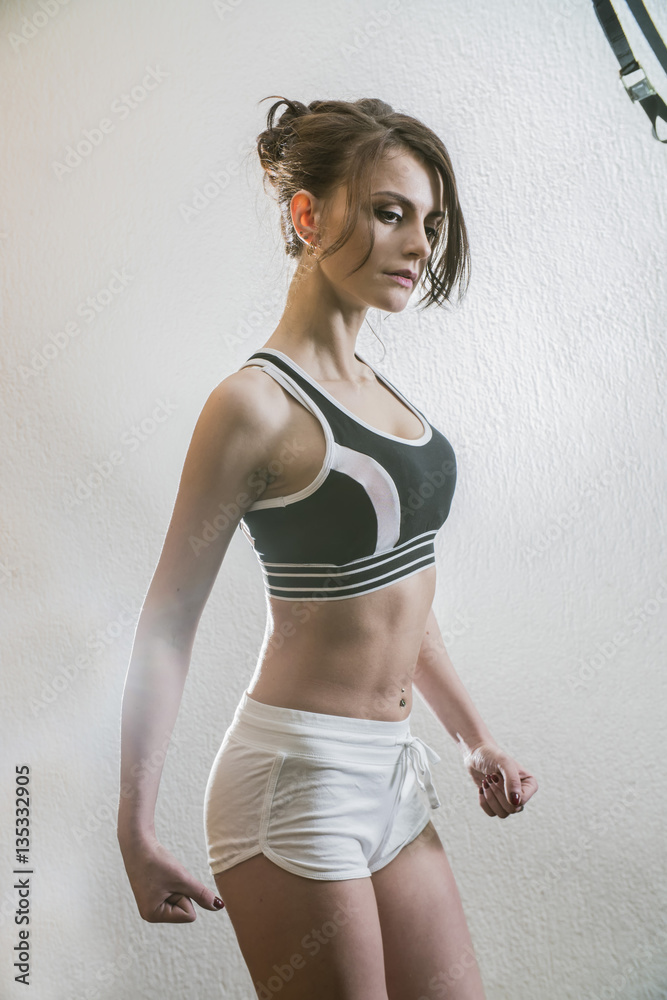 Obraz premium beautiful young girl is engaged in sports and fitness