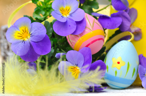 œufs de Pâques parmi fleurs et plume
