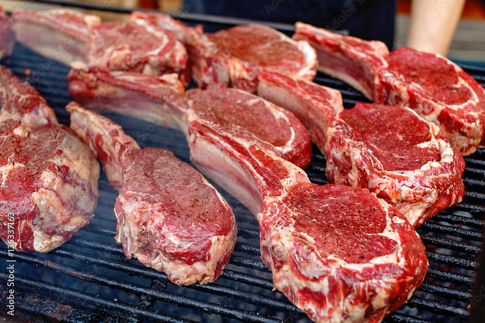 Raw fresh meat rib eye steak on grill