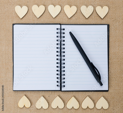 Wood hearts on hessian texture background, valentine background. photo