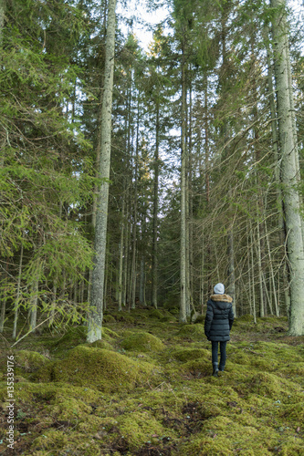 Woman on her way into a big forest