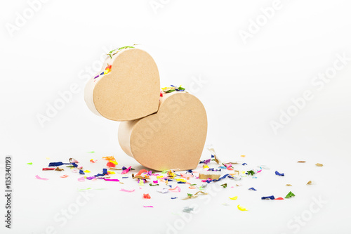 Heart shaped gift boxex with colored confetti isolated on white for Valentines day and March 8 photo