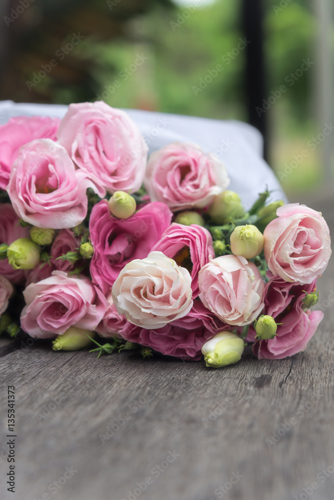 Beautiful bouquet of pink roses on wooden background Beautiful bouquet of pink roses on wooden background