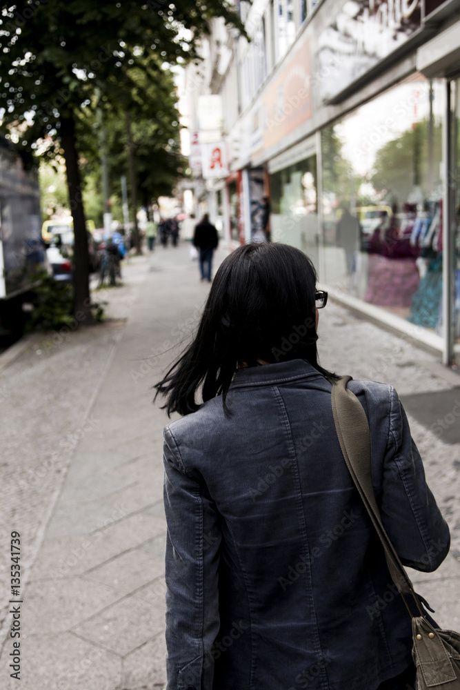 Behind Woman Walking on Pavement