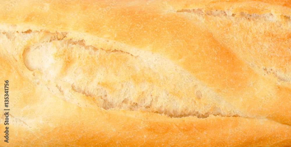 Bread loaf close-up. Background in brown-orange colors.