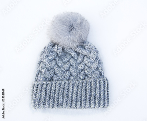 Gray knitted woolen hat with fur pompom