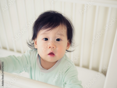 Baby girl in cot bed