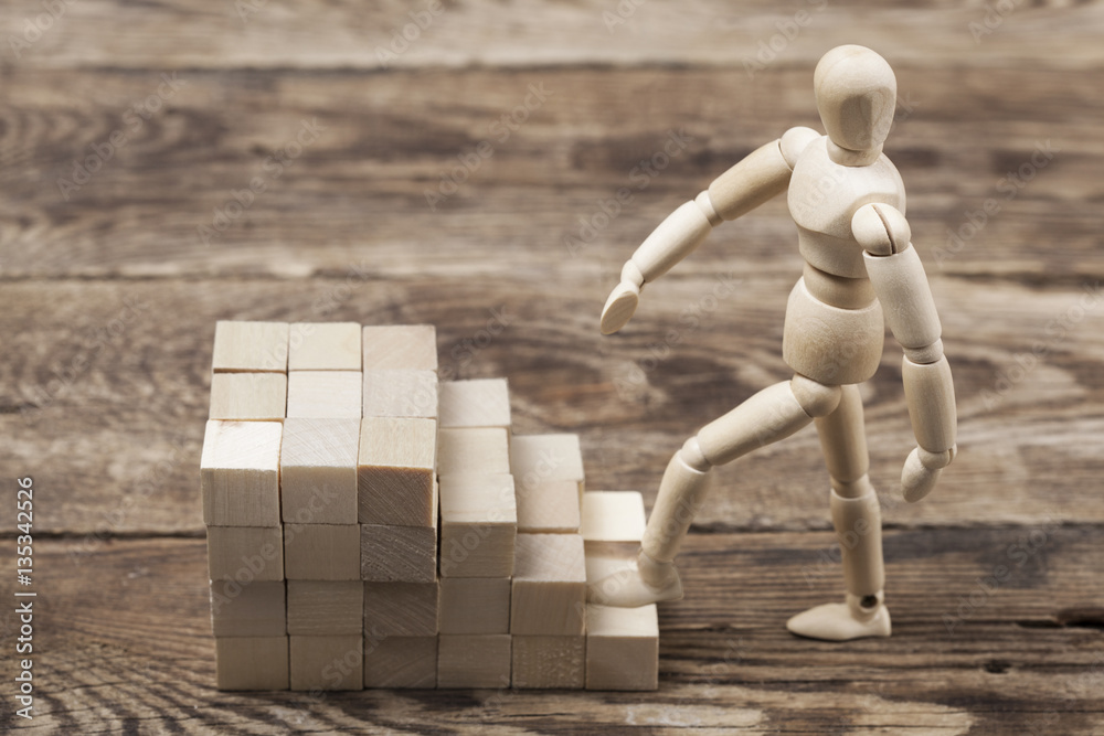 Man climbing up to high stack of blocks Man climbing up to high stack of blocks
