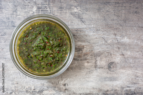 chimichurri sauce on wooden background.Top view copyspace photo