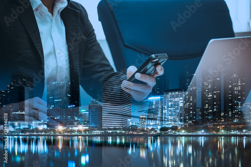 Double exposure of businessman  holding smartphone and touching photo