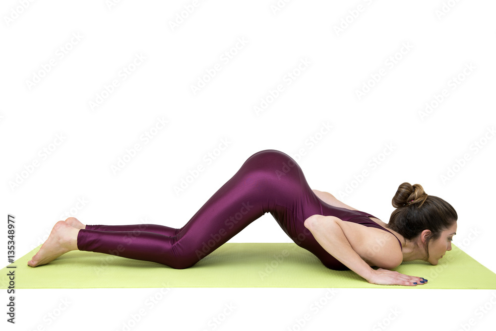 Young woman practicing yoga in the studio