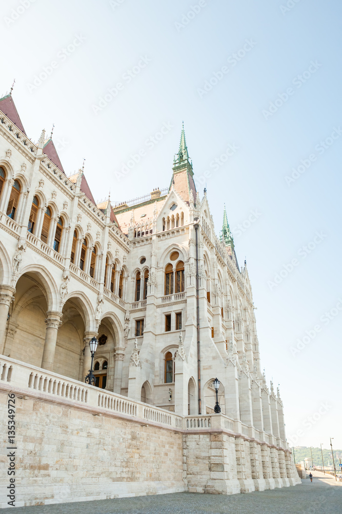 Building of Hungarian National Parliament viewed from the side of the Dunabe river in Budapest, Hungary