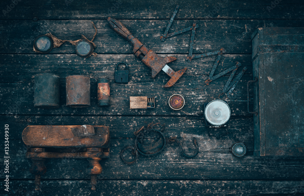 Old and rusty tools on a old board background. Flat lay and top view