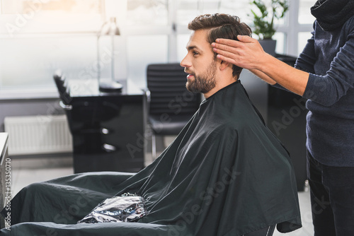 Canvas-taulu Attractive guy getting service in beauty salon