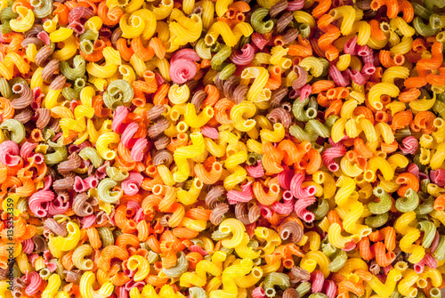 Colorful pasta kavatappi, background, top view, copy space