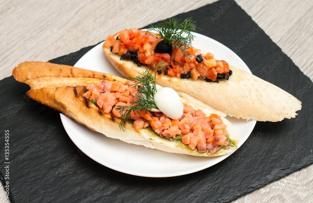 Sandwich with salmon and tomatoes for breakfast. . View from above Sandwich with salmon and tomatoes for breakfast. . View from above