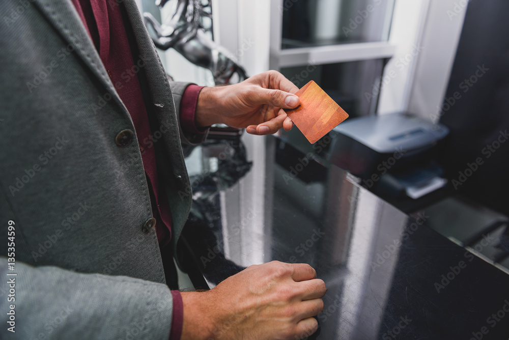Naklejka premium Young businessman undergoing payment at hairdressers