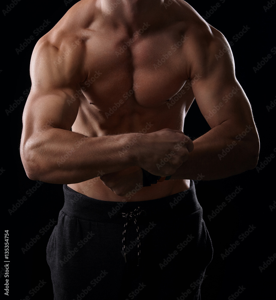 Fototapeta premium Muscular man showing his muscular arms