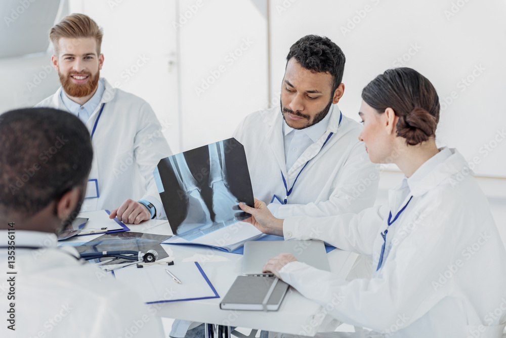 Professional general practitioners discussing radiograph Professional general practitioners discussing radiograph