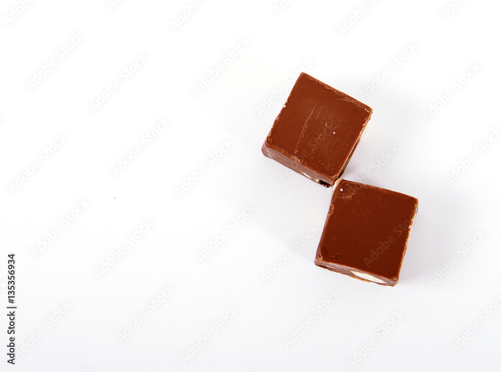 piece of chocolate on white piece of chocolate on white
