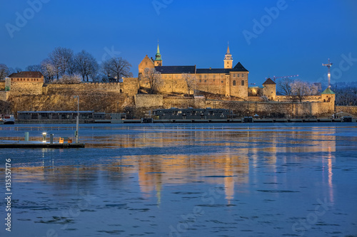 Evening view of the Akershus Fortress in Oslo, Norway. View from the Aker Brygge Marina across the Pipervika bay of Oslofjord.