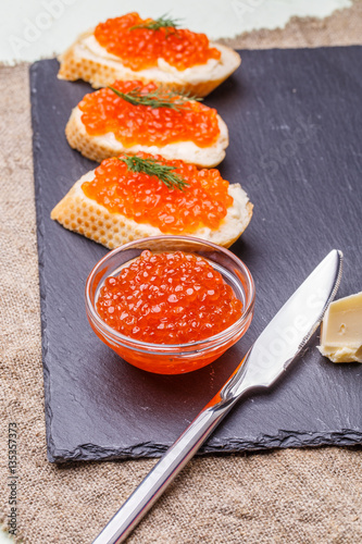 Baguette with red caviar, knife