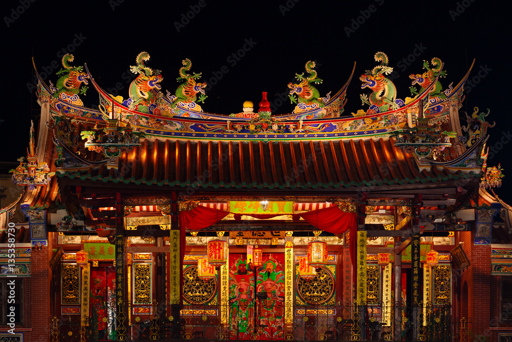 Decorated roof and second floor of traditional old chinese temple Seh Tek Tong Cheah Kongsi in Georgetown, Penang, Malaysia. UNESCO world heritage site. Night view.