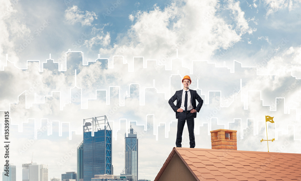 Engineer man standing on roof and looking away. Mixed media Engineer man standing on roof and looking away. Mixed media