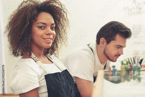 Attractive smiling barista working in cafe