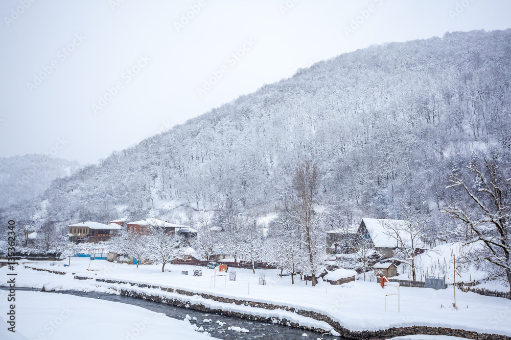 village covered with snow on the pass Rikota, Georgia