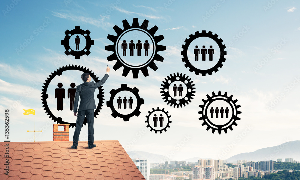 Businessman on house roof presenting teamwork and connection con Businessman on house roof presenting teamwork and connection con