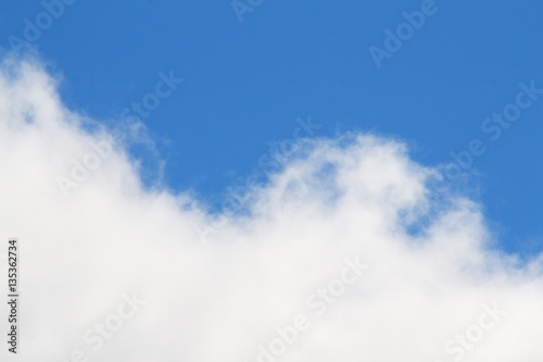 White clouds in a bright blue sky. Sunny day