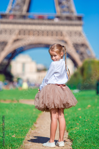Adorable little girl near the Eiffel tower during summer vacation in Paris © travnikovstudio