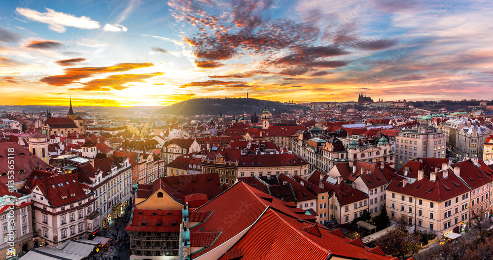 Fototapeta premium Most mystical and mysterious city in Europe. Prague through the eyes of birds with magnificent sunset and sky over the traditional houses with red roofs. Old town square, Prague, Czech Republic