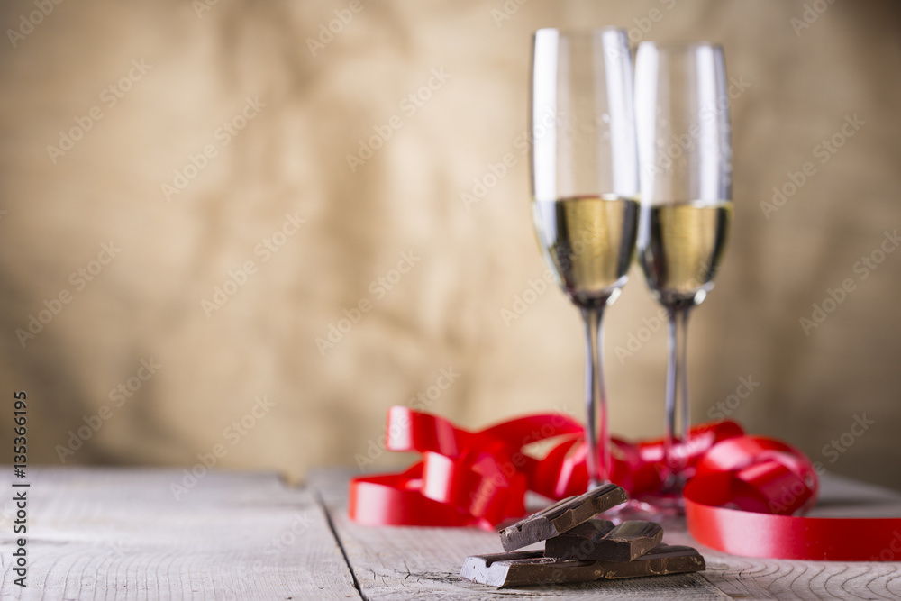 chocolate and two champagne glasses with red ribbon .valentines chocolate and two champagne glasses with red ribbon .valentines