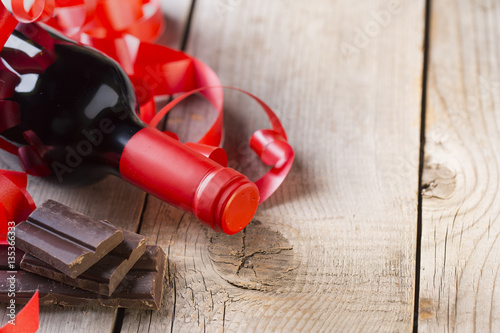 chocolate and bottle of red vine with red ribbon .valentines day